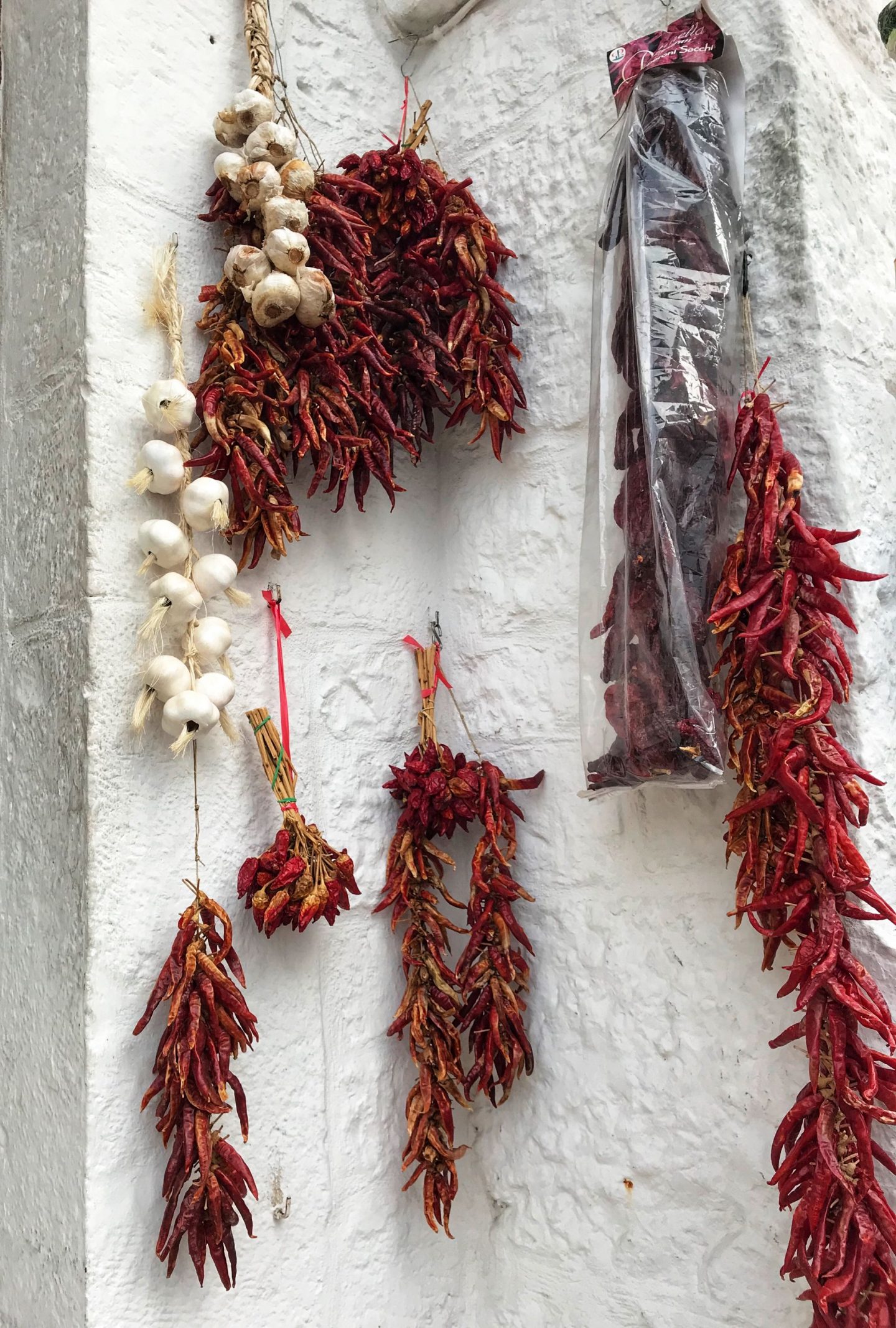 Chillis and garlic hanging from the walls in Alberobello
