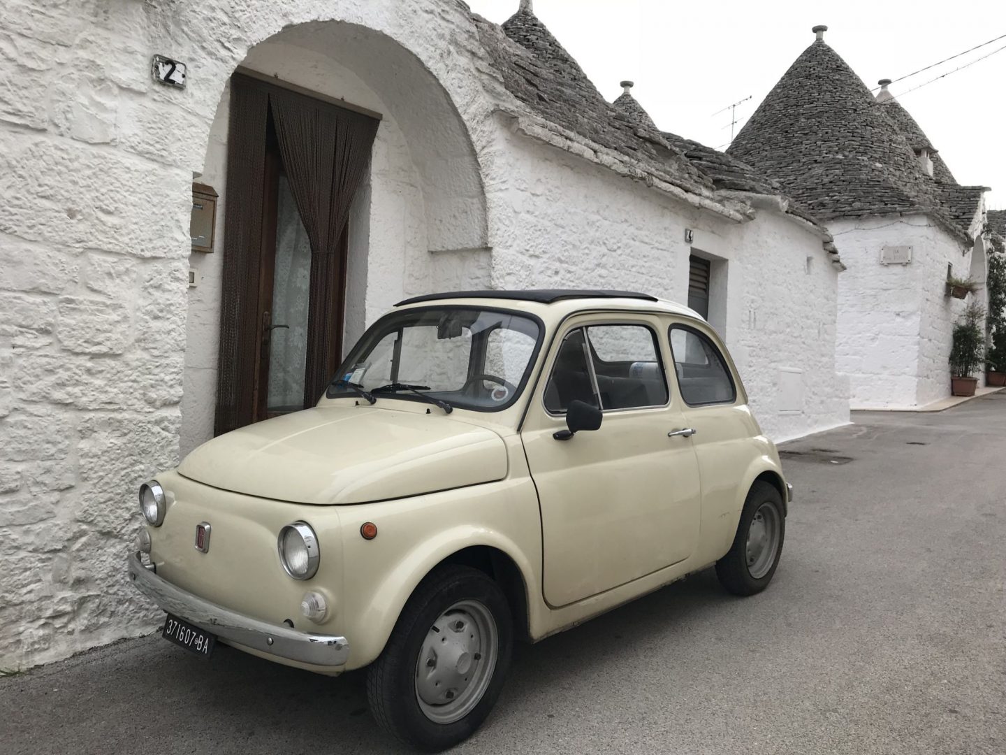 Puglia road trip mini fiat 500 in Alberobello Puglia Southern Italy
